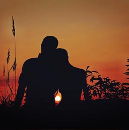 A silhouette of a lovely couple enjoying a beautiful sunset