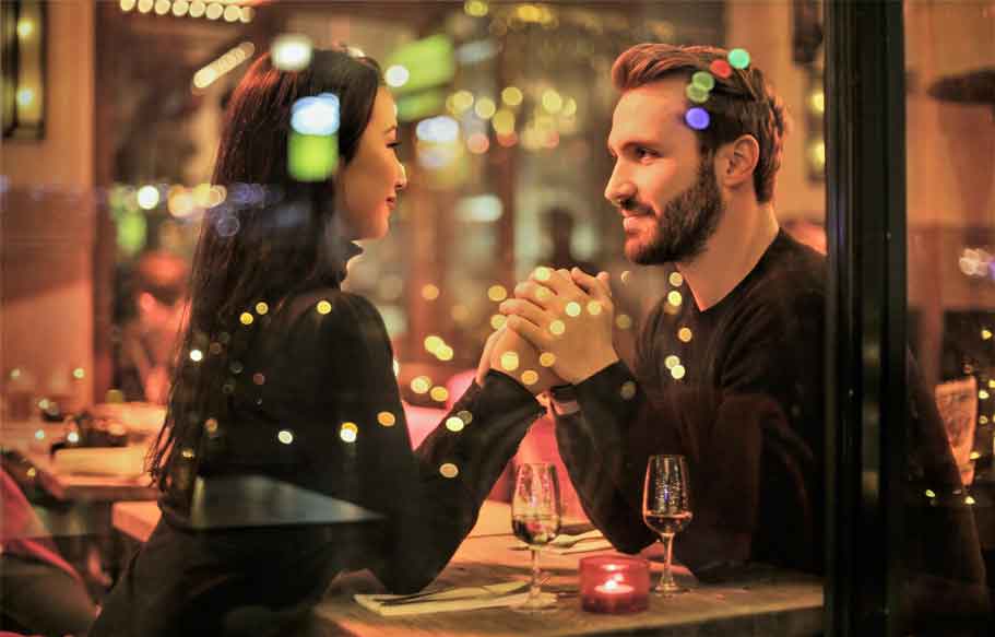 A photo of a man and a foreign woman on a date.