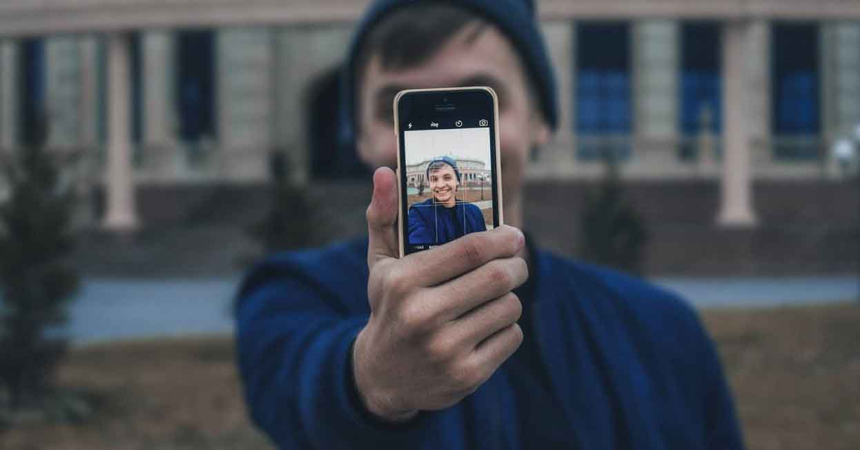 A photo of a man in his phone