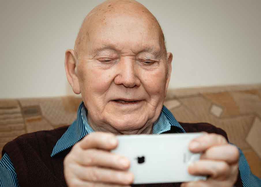 An elderly man on an iphone