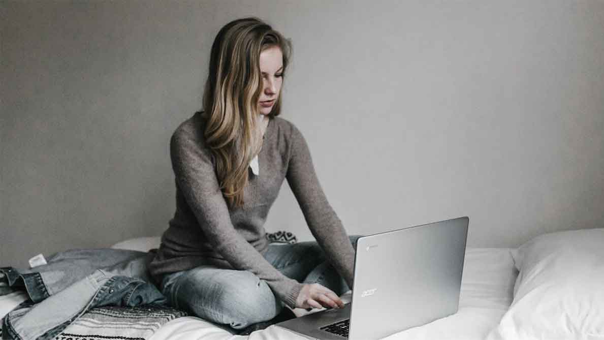 A photo of a woman using her laptop